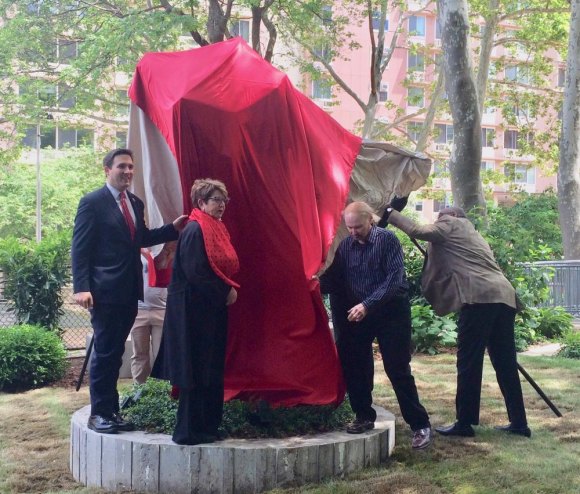 Why build a memorial to Nellie Bly? Susan Rosenthal (red scarf) unveiling "The Plinth," a new stop along the Island of Art Trail, last year.